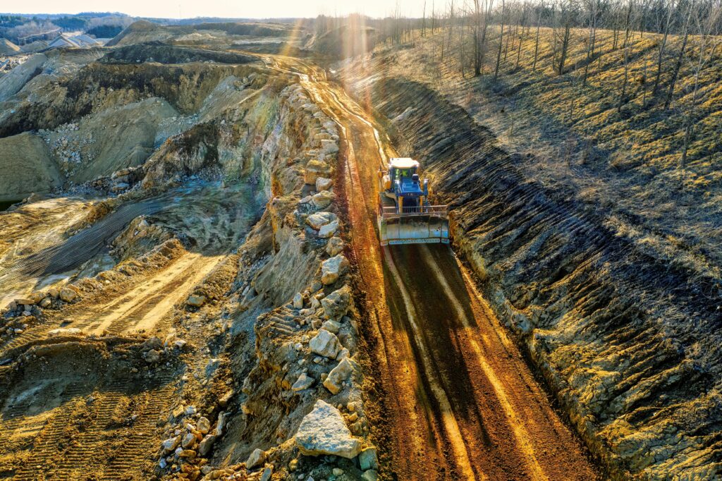pexels tomfisk 12236053 – TCL Consulting Bulldozer grading a mountain slope using cut and fill techniques based on earthwork takeoffs, preparing a road through rugged terrain.
